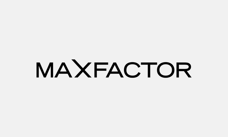 Max Factor – černé logo na světle šedém pozadí